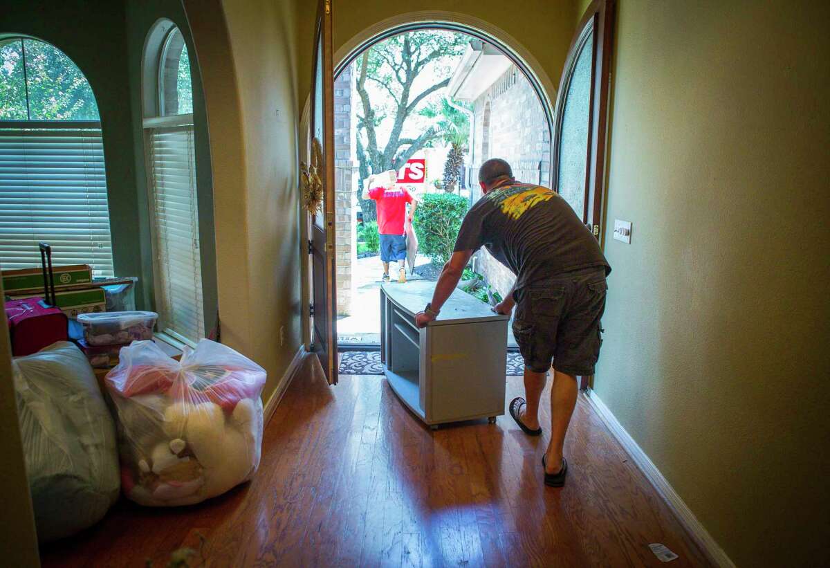 Matt Sprague packs up the last of his belongings from his family's home in west Houston after closing on the sale of the home, which was bought by the iBuyer Opendoor. The recent influx of iBuyers into the Housotn market has made it easier for homeowners to sell their houses at a price they want.