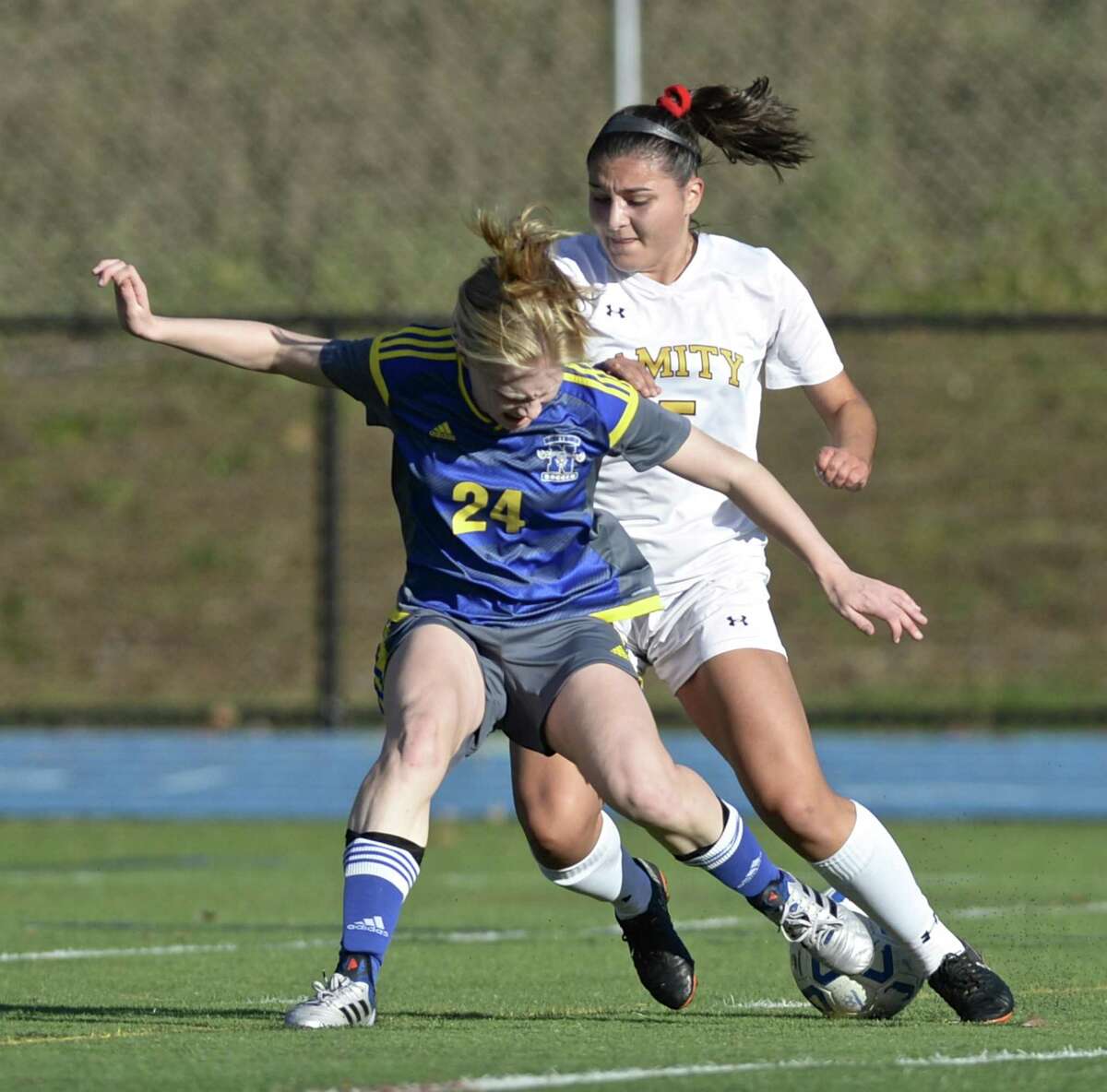 Newtown's Ally McCarthy (24) gets the ball away form Amity's Julia Potter (5) in the girls LL soccer game between Amity and Newtown high schools, Wednesday, November 7, 2018, at Newtown High School, Newtown, Conn. Newtown defeated Amity 1-0.