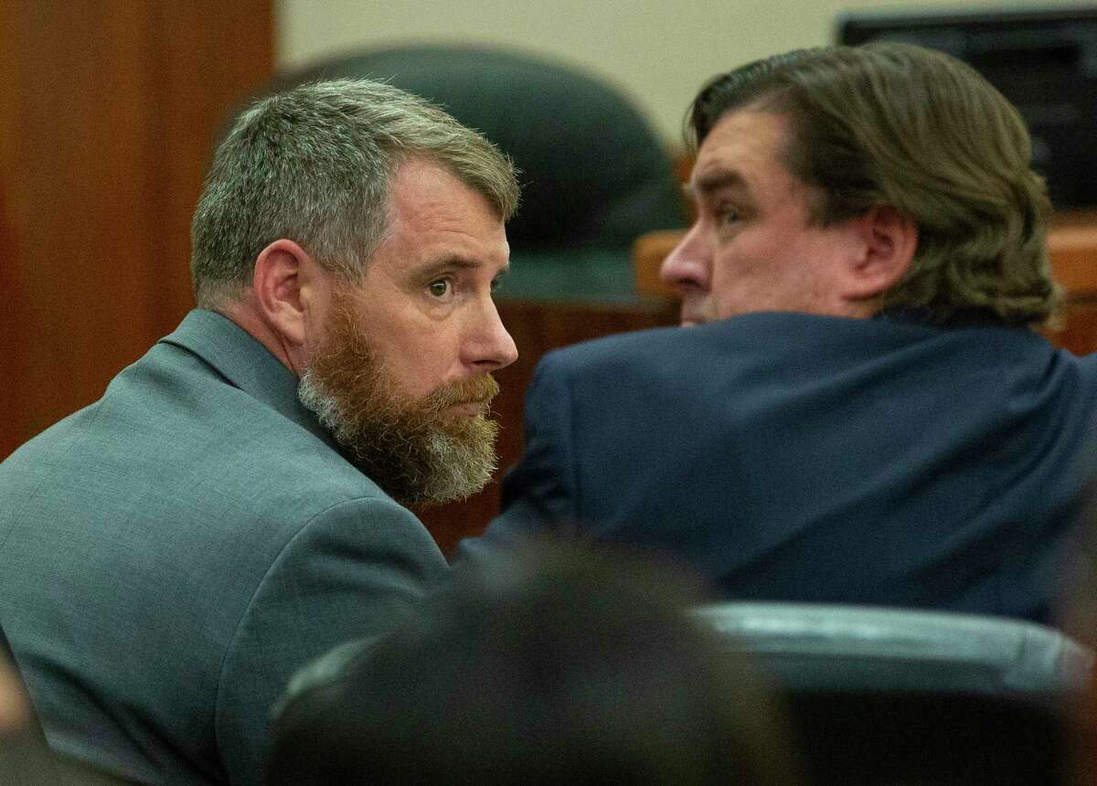 Terry Bryan Thompson (left) looks at his lawyer shortly before being told that a jury agreed on a 25-year prison sentence for him for the choking death of John Hernandez.