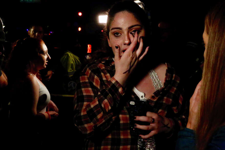 Sarah Rose DeSon talks to friends after a shooter wounded seven Wednesday night on November 8, 2018 in Thousand Oaks, California. The gunman burst into the bar around 11:20 p.m., cloaked in all black as he threw smoke bombs and began shooting at targets as young as 18 inside the Borderline Bar & Grill, authorities and witnesses said. Photo: Al Seib/Getty Images / 2018 Los Angeles Times