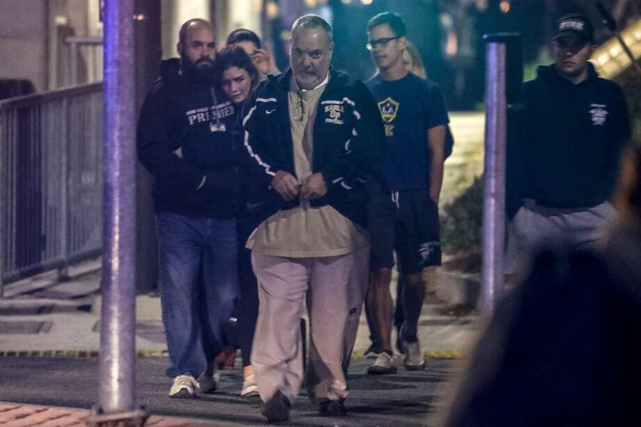 Witnesses console each other near the Borderline Bar & Grill after a shooter wounded seven Wednesday night on November 8, 2018 in Thousand Oaks, California. The gunman burst into the bar around 11:20 p.m., cloaked in all black as he threw smoke bombs and began shooting at targets as young as 18 inside the Borderline Bar & Grill, authorities and witnesses said. Photo: Irfan Khan/Getty Images