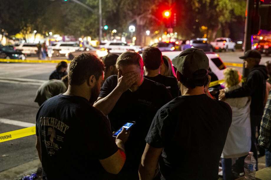 People stand in a parking lot along South Moorpark Road in the aftermath of a mass shooting at Borderline Bar & Grill after a gunman opened fire late Wednesday at a Thousand Oaks bar packed with hundreds of people attending a popular event for college students, causing multiple fatalities on November 8, 2018 in Thousand Oaks, California. The gunman burst into the bar around 11:20 p.m., cloaked in all black as he threw smoke bombs and began shooting at targets as young as 18 inside the Borderline Bar & Grill, authorities and witnesses said. Photo: Kent Nishimura/Getty Images