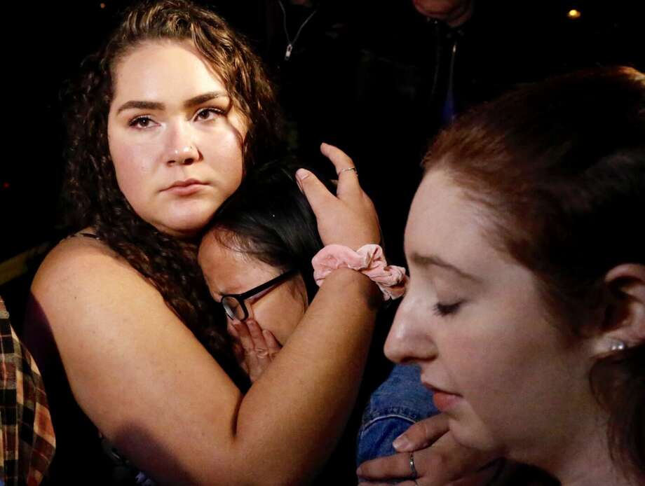 Nellie Wong cries as Chyann Worrell holds her and Erika Sigman (R) were all inside when shooting started inside the Borderline Bar & Grill when a shooter wounded seven Wednesday night on November 8, 2018 in Thousand Oaks, California. The gunman burst into the bar around 11:20 p.m., cloaked in all black as he threw smoke bombs and began shooting at targets as young as 18 inside the Borderline Bar & Grill, authorities and witnesses said. Photo: Al Seib/Getty Images