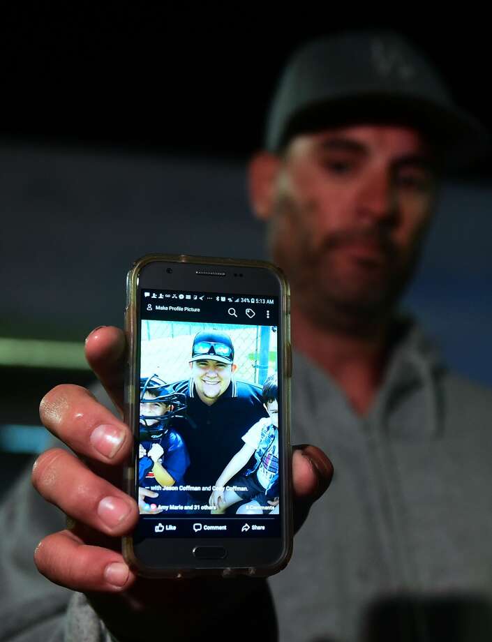 Jason Coffman displays a photo of his son Cody outside the Thousands Oaks Teene Center where he came hoping to find his son who was at the Borderline Bar and Grill in Thousand Oaks, California, on November 8, 2018. - Twelve people, including a police sergeant, were shot dead in a shooting at the bar close to Los Angeles, police said Thursday. All the victims were killed inside the bar in the suburb of Thousand Oaks late on November 7, including the officer who had been called to the scene, Sheriff Geoff Dean told reporters. The gunman was also dead at the scene, Dean added. Photo: FREDERIC J. BROWN/AFP/Getty Images
