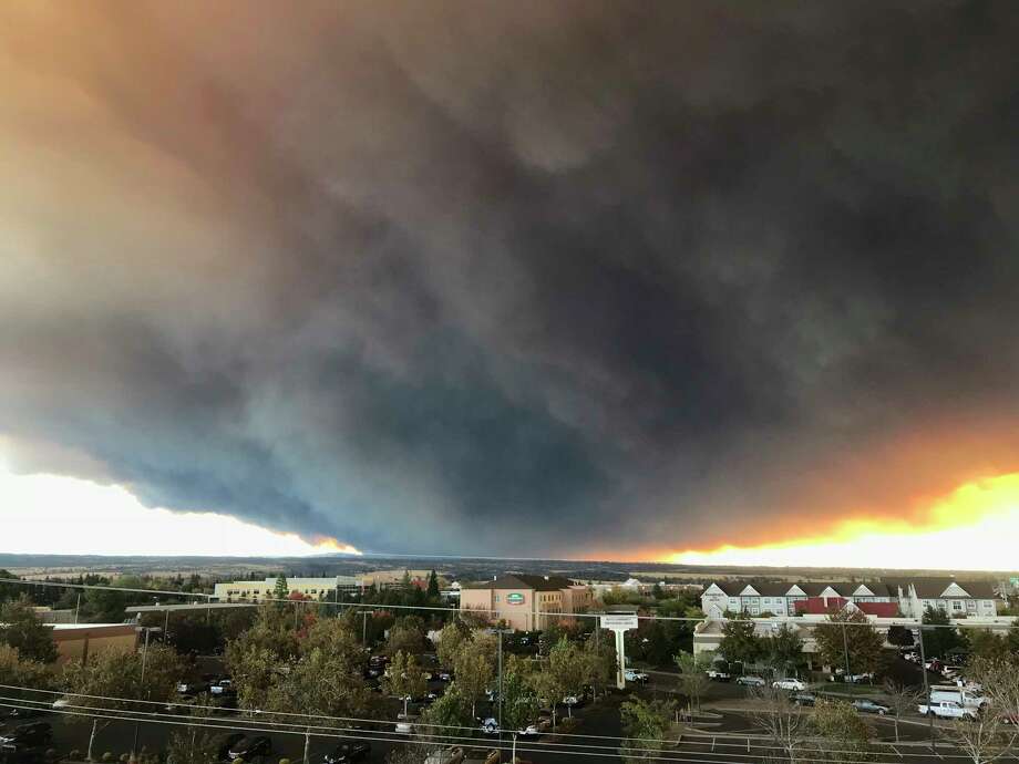 The massive plume from the Camp Fire, burning in the Feather River Canyon near Paradise, Calif., wafts over the Sacramento Valley as seen from Chico, Calif., on Thursday, Nov. 8, 2018. Authorities in Northern California have ordered mandatory evacuations in a rural area where the wildfire has grown to 1,000 acres (405 hectares) amid hot and windy weather. (David Little/Chico Enterprise-Record via AP) Photo: David Little, AP / Media News Group