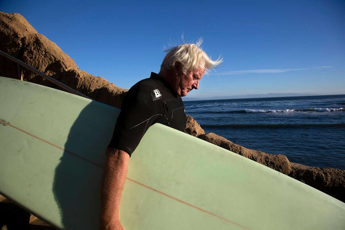 Legendary surfer Richard "Frosty" Hesson heads out to catch some waves at Pleasure Point on Monday, 10/29, 2018 in Santa Cruz, California. Hesson was depicted by Gerard Butler in the film Chasing Mavericks.