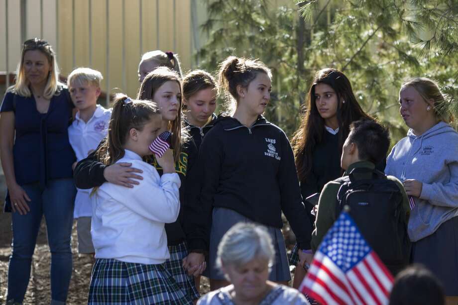 Young people talk after the procession carrying the body of Ventura County Sheriff Sgt. Ron Helus, who was killed in a mass shooting at the Borderline Bar and Grill, left Los Robles Hospital on November 8, 2018 in Thousand Oaks, California. 12 people have died including the sergeant plus the gunman. Photo: David McNew/Getty Images