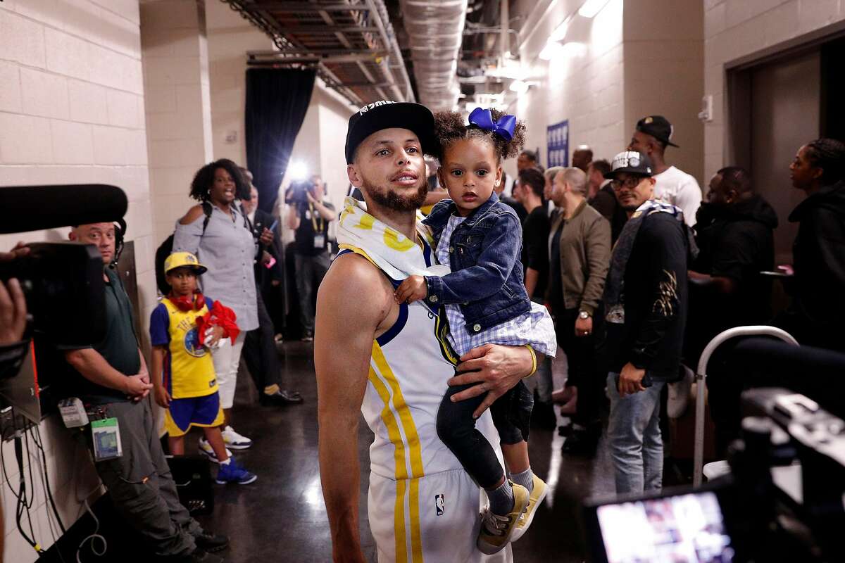 Stephen Curry holds his daughter Ryan after the Golden State Warriors defeated the Houston Rockets in Game 7 of the Western Conference Finals 101-92 to advance to the NBA Finals at the Toyota Center in Houston, Texas, on Monday, May 28, 2018.
