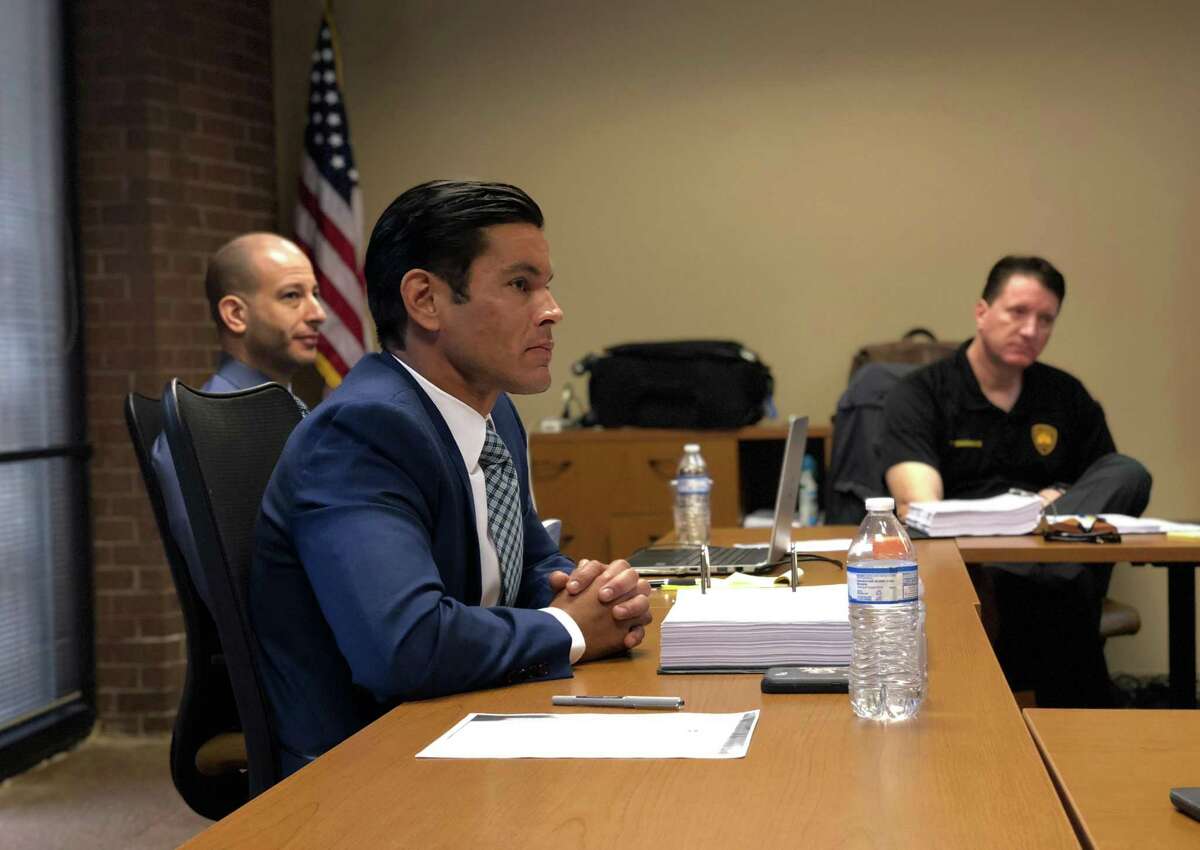 Matthew Luckhurst, (foreground) a San Antonio police officer for five years, was indefinitely suspended in October 2016. This November 2018 photo is from an arbitration hearing where Luckhurst was petitioning to keep his job. 