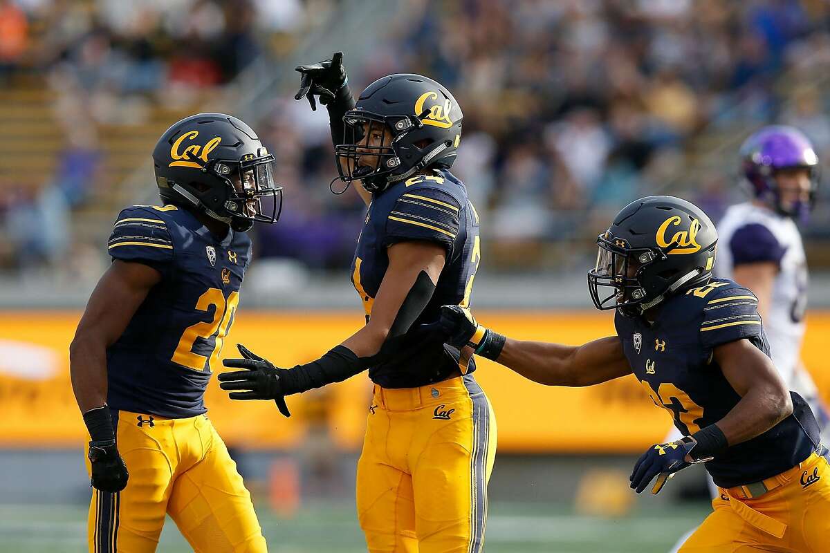 BERKELEY, CA - OCTOBER 27: Camryn Bynum (center) #24 of the California Golden Bears celebrates after making an interception against the Washington Huskies at California Memorial Stadium on October 27, 2018 in Berkeley, California. (Photo by Lachlan Cunningham/Getty Images)