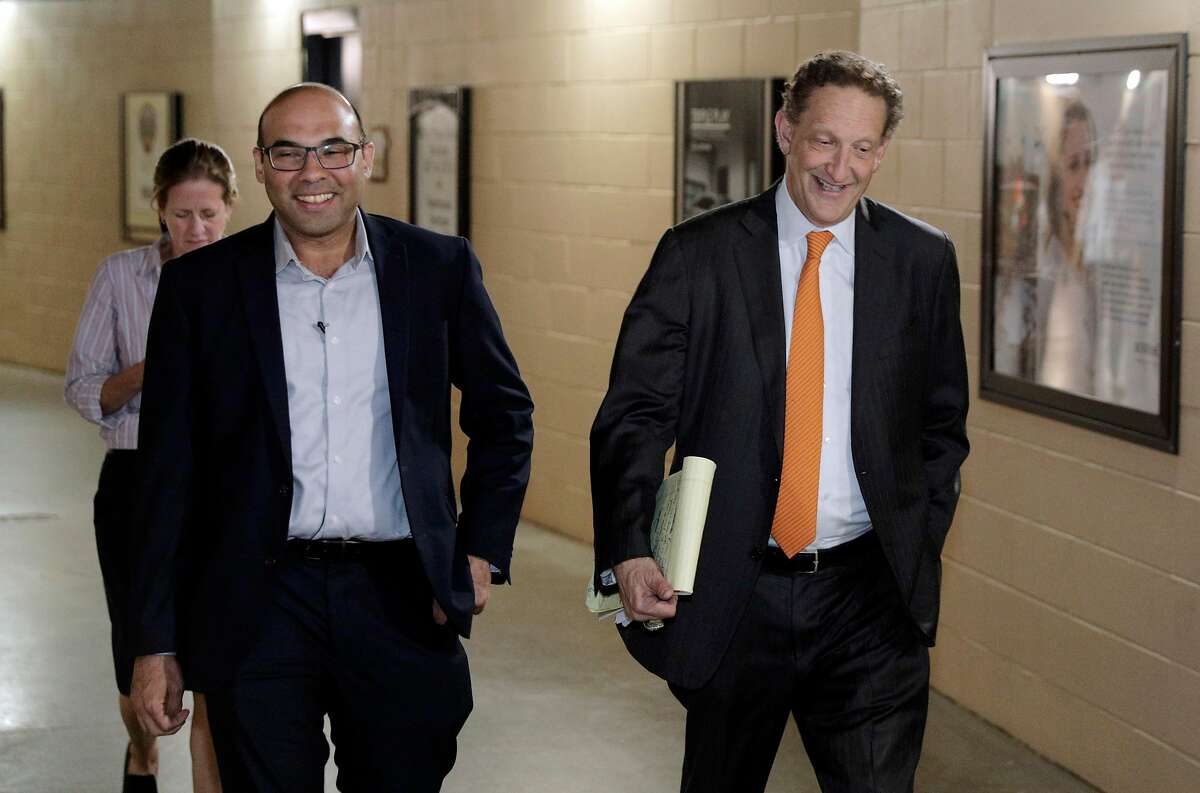 Farhan Zaidi walks toward the press conference room with Giants CEO Larry Baer at AT&T Park.