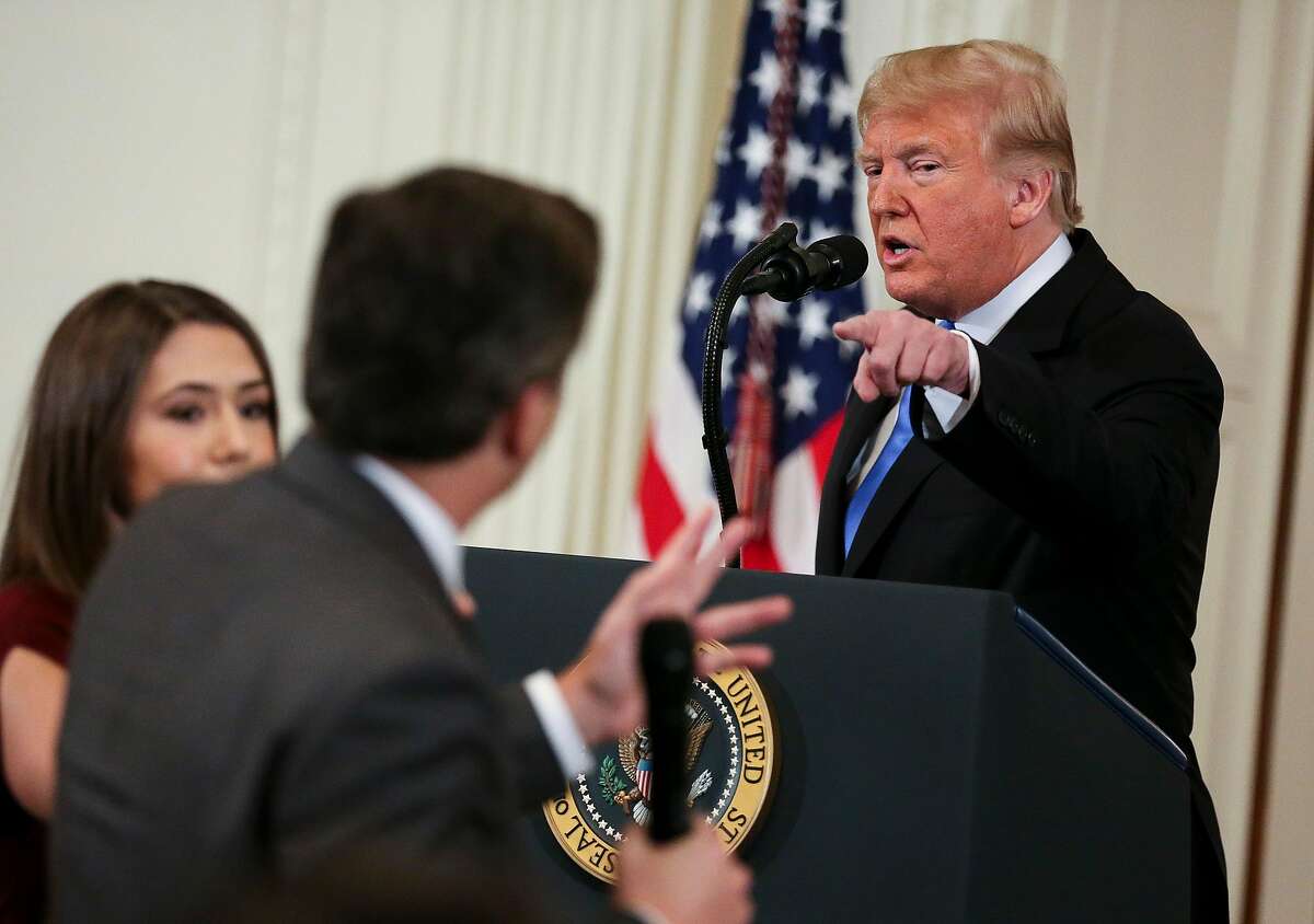 A White House staff member, left, tries to take away the microphone from CNN White House correspondent Jim Acosta during an exchange with President Donald Trump on Wednesday, Nov. 7, 2018, in Washington, D.C. (Oliver Contreras/Sipa USA/TNS)