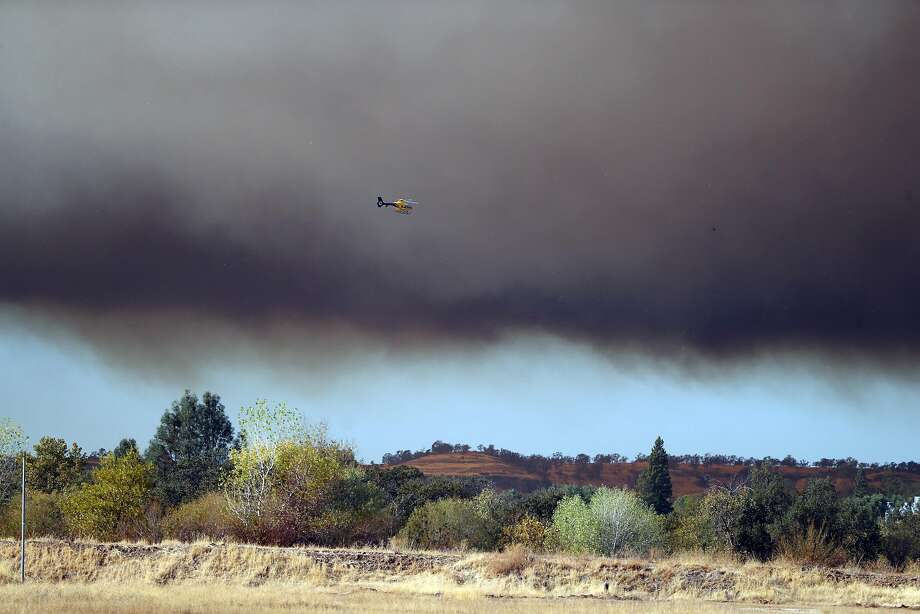 A helicopter flies towards the Camp Fire in Butte County, Calif.. on Thursday, November 8, 2018. Photo: Scott Strazzante, The Chronicle