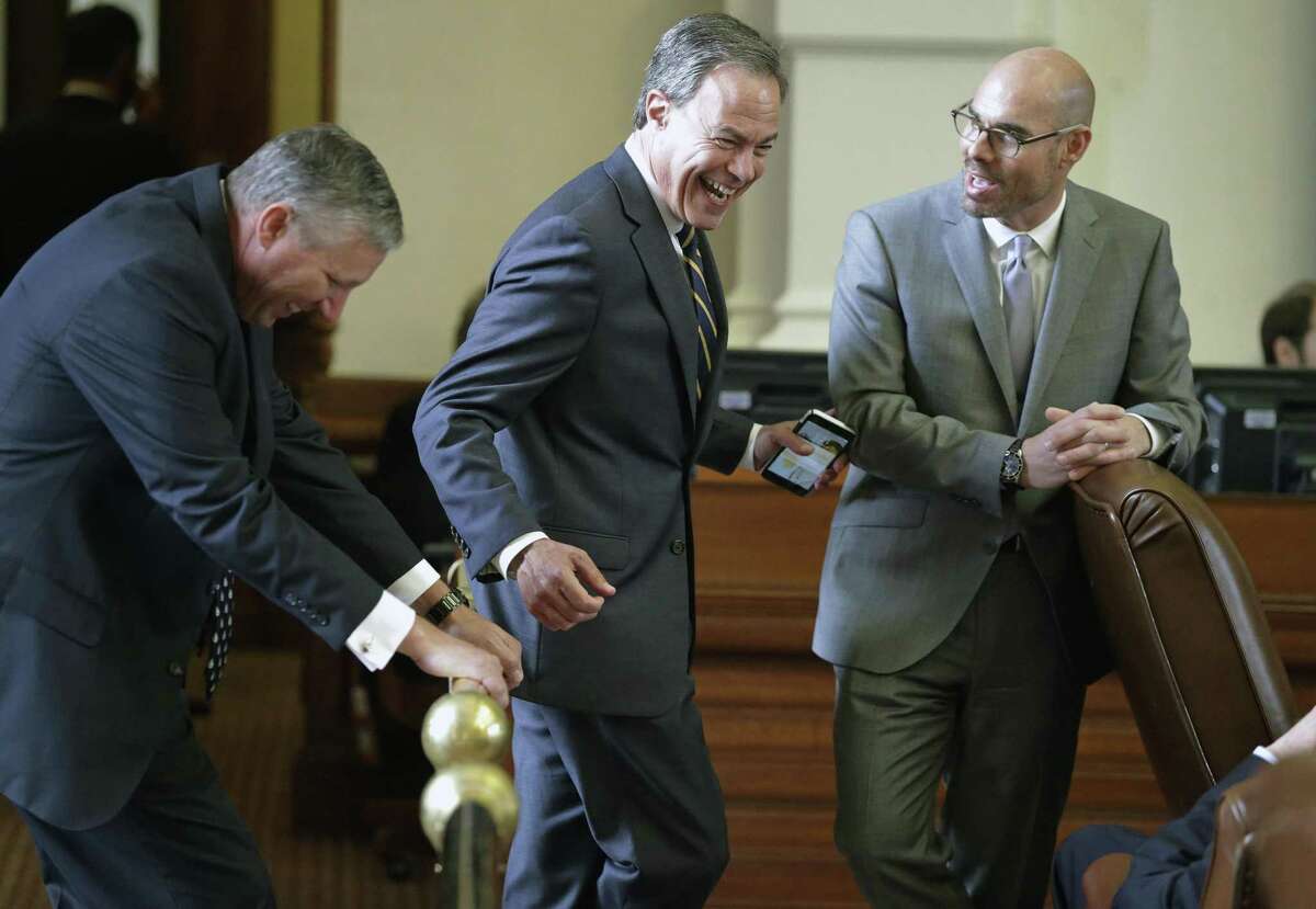 Speaker Joe Straus shares some laughs on the rail with Representative Drew Springer, R-Gainesville (left), and Representative Dennis Bonnen, R-Angleton during the Texas House of Representatives meeting on April 19, 2017.