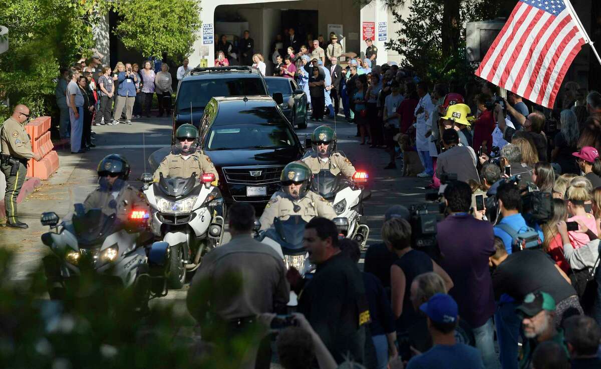 A law enforcement motorcade escorts the body of Ventura County Sheriff's Department Sgt. Ron Helus from the Los Robles Regional Medical Center Thursday, Nov. 8, 2018, in Thousand Oaks, Calif., after a gunman opened fire Wednesday night inside a country music bar killing multiple people including Helus. (AP Photo/Mark J. Terrill)