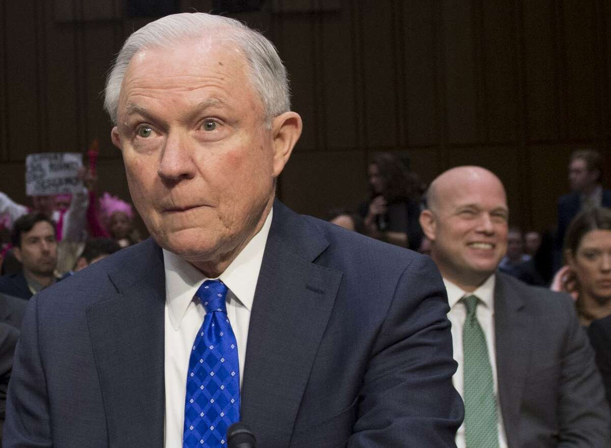 In this file photo taken on October 18, 2017 U.S. Attorney General Jeff Sessions arrives to testify as Matthew G. Whitaker (R), chief of staff to Sessions smiles during a Senate Judiciary Committee hearing on Capitol Hill in Washington, DC.