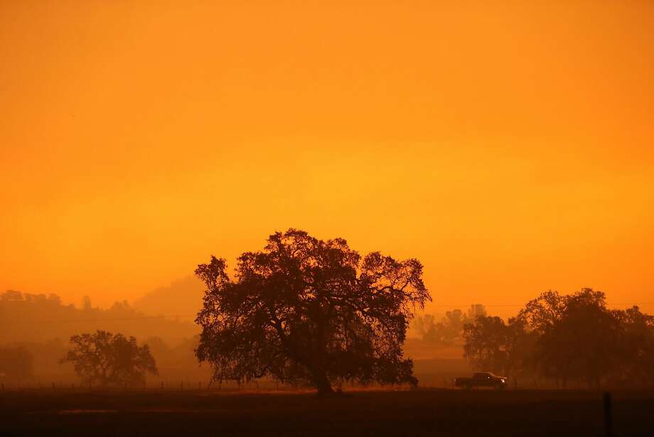 A pick up truck drives on a road during Camp Fire west of Paradise, Calif.. on Friday, November 9, 2018. Photo: Scott Strazzante, The Chronicle