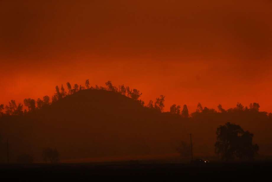 A pick up truck drives on a road during Camp Fire west of Paradise, Calif.. on Friday, November 9, 2018. Photo: Scott Strazzante, The Chronicle