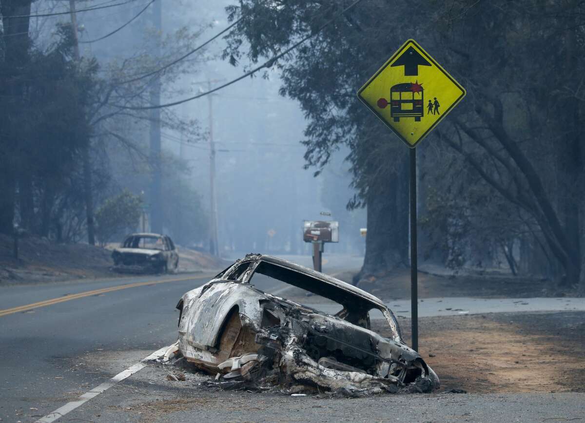 An abandoned vehicle sits in a ditch on Pentz Road in Paradise, Calif., Thursday, November 8, 2018, after the neighborhood was evacuated in the wake of the Campfire.