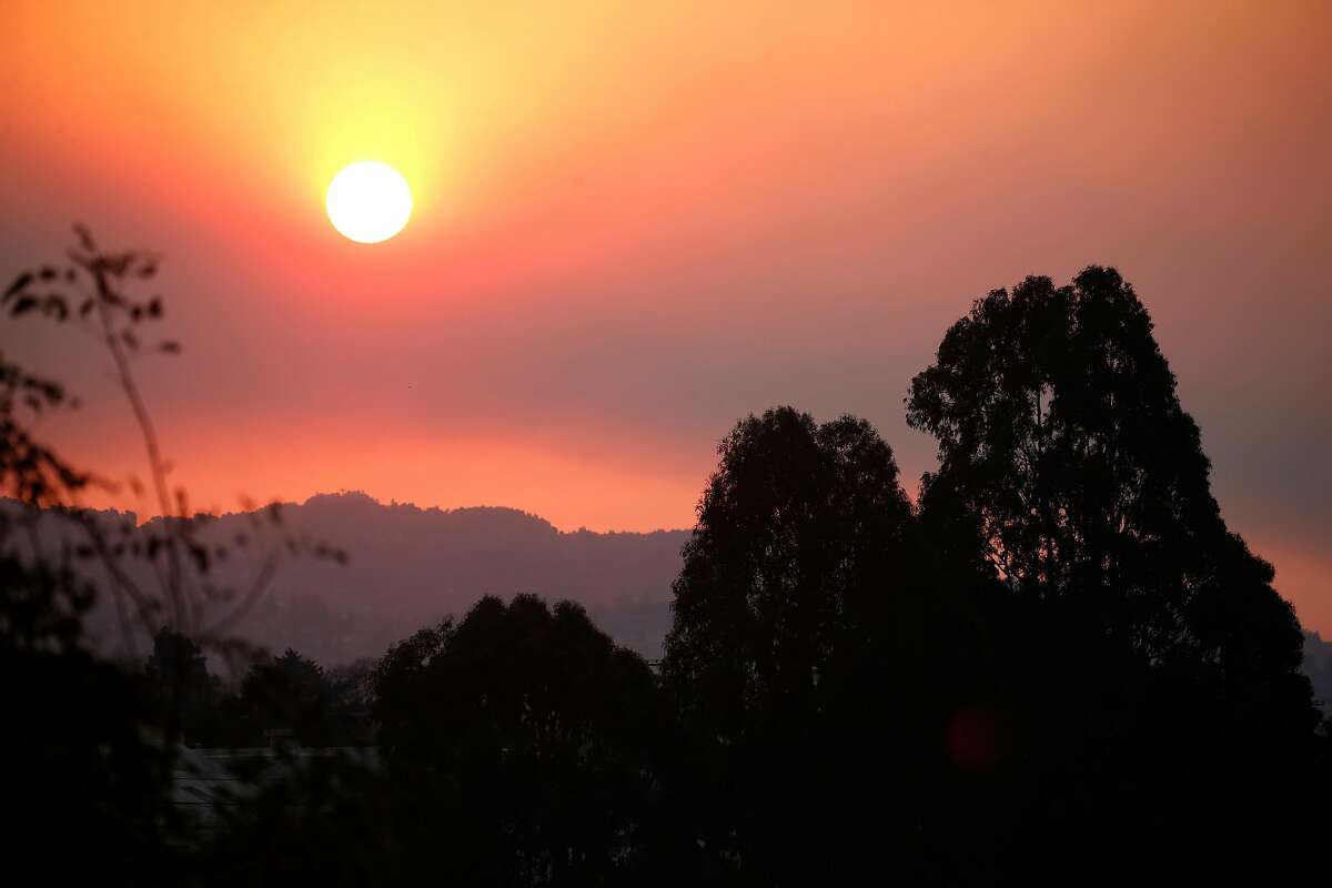 The sun rises above the East Bay hills through a smoky haze in Berkeley, Calif. on Friday, Nov. 9, 2018. Air quality in the region remains unhealthy while smoke from the Camp Fire in Butte County continues to drift to the south.