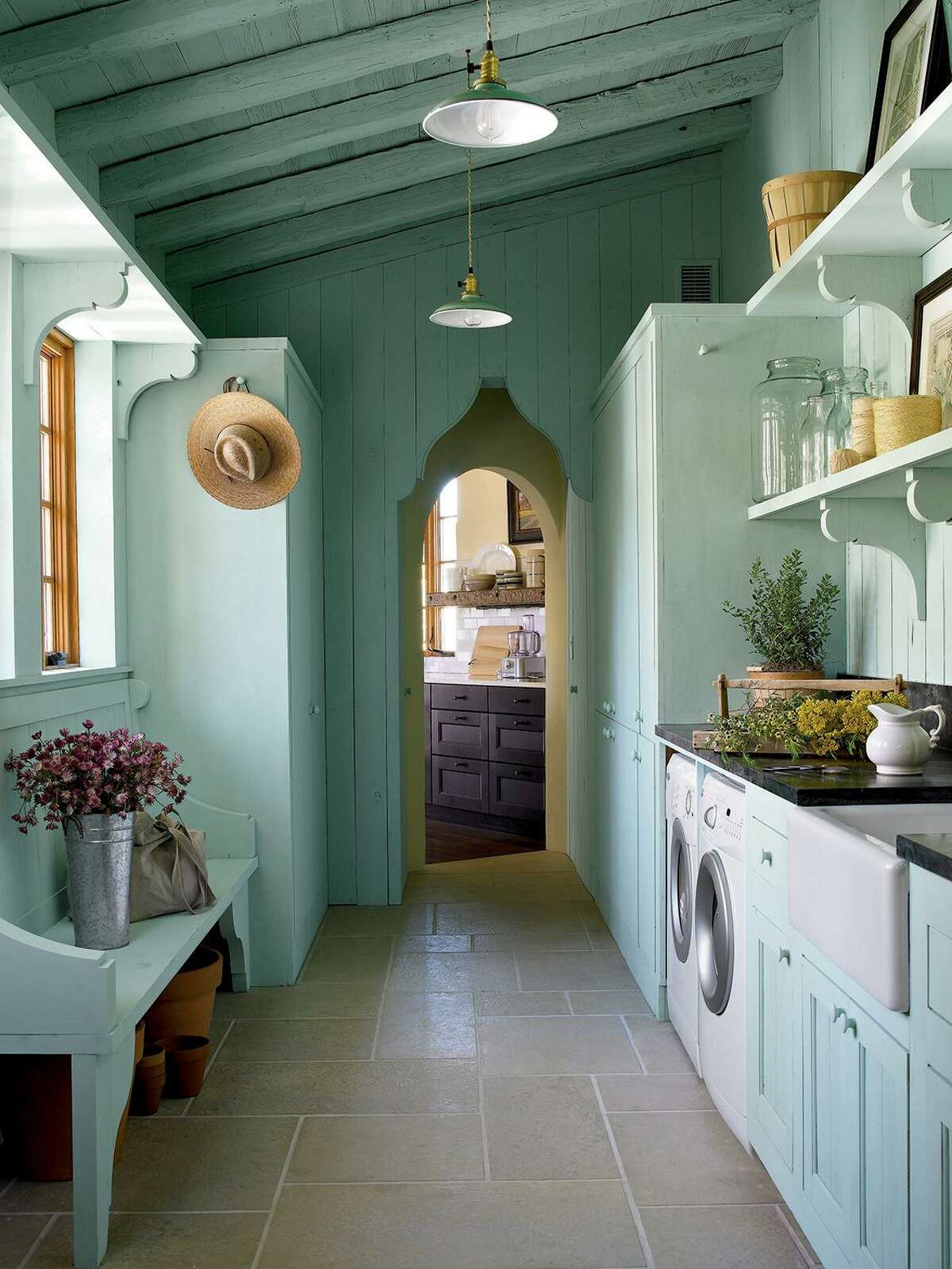 As an example of how laundry rooms are serving multiple purposes, this French farmhouse-style one doubles as a flower room for preparing bouquets and other floral arrangements.