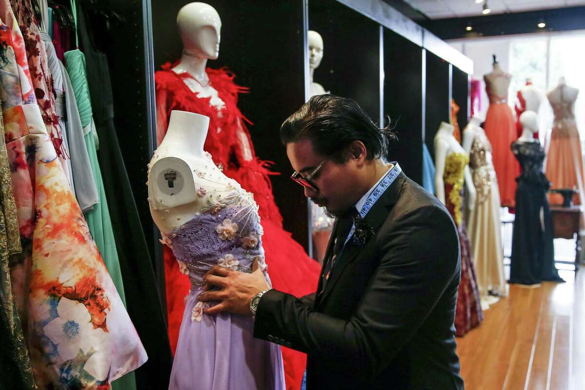 Fashion designer Danny Nguyen moves a mannequin at his studio.