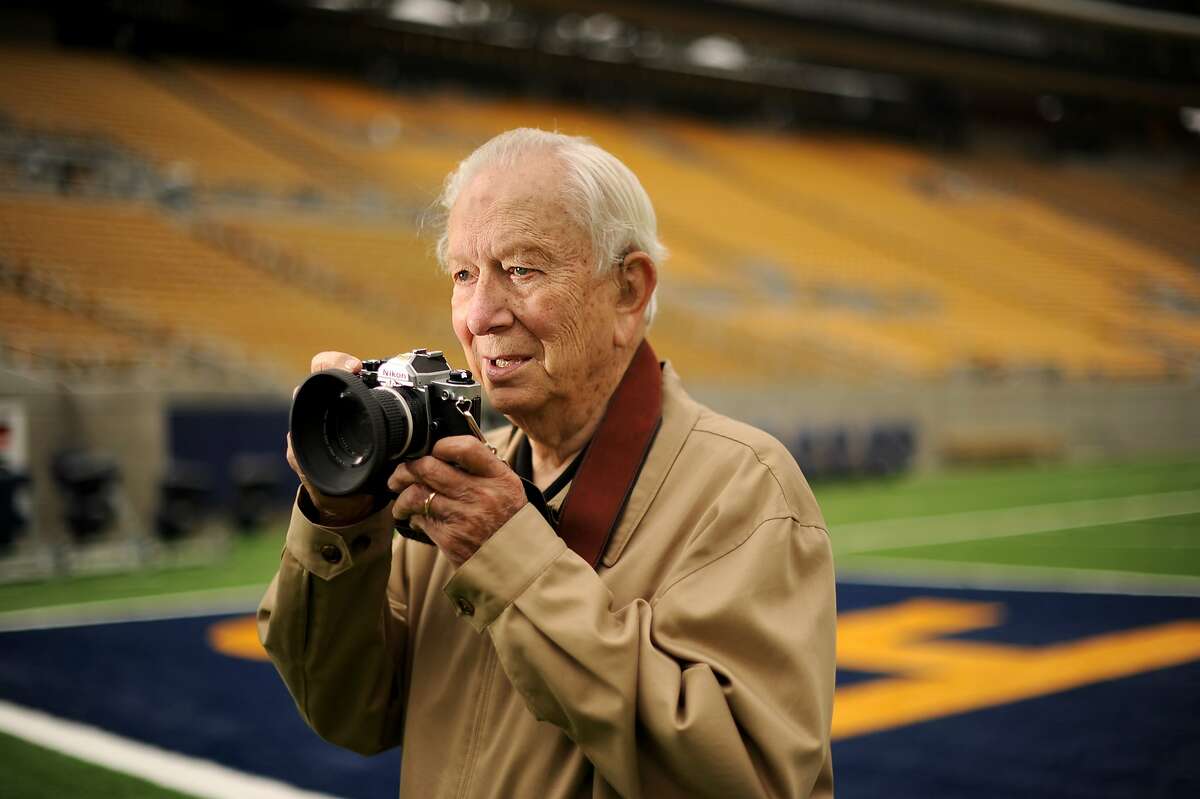 Photographer Bob Stinnett stands in Memorial Stadium on Thursday, Oct. 4, 2012, in Berkeley, Calif. Stinnett used the Nikon FM2 camera he is holding to photograph "The Play," a series of passes that left Cal beating the Cardinals 25-20 in a 1982 game.