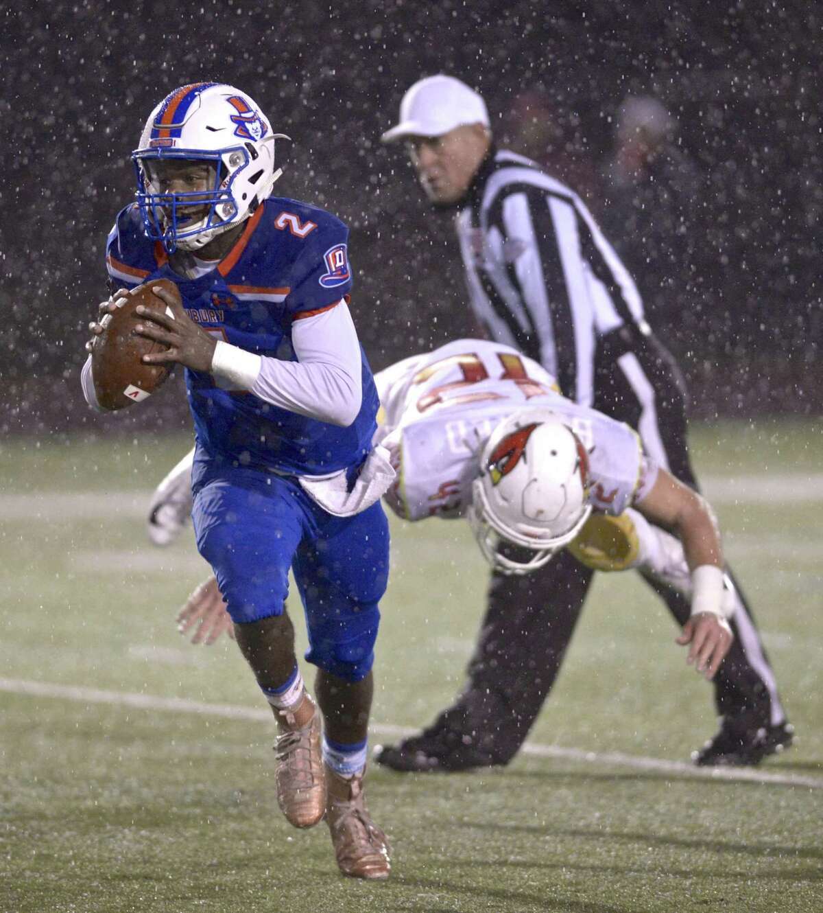 Danbury quarterback Malachi Hopkins (2) scrambles out of the backfield ad away from Greenwich's Gramoz Bici (42) in the football game between Greenwich and Danbury high schools, Friday night, November 9, 2018, at Danbury High School, Danbury, Conn.