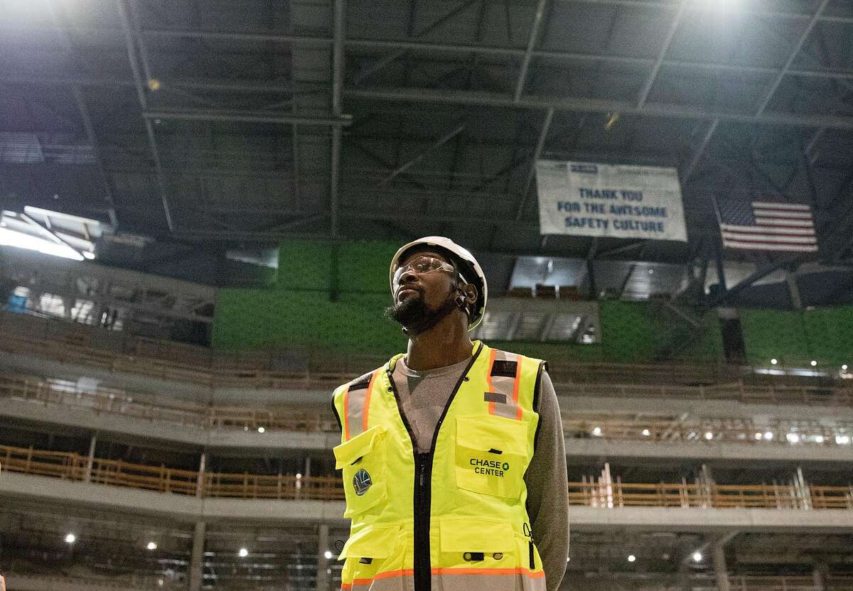 Warriors Kevin Durant looks up while standing in the middle of the future site of the main arena inside the Chase Center while under construction along the waterfront near the Mission Bay neighborhood of San Francisco, Calif. Friday, Nov. 9, 2018.