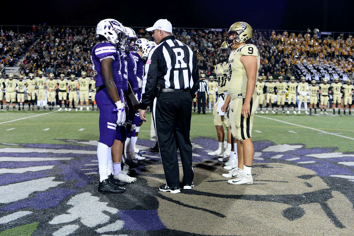 Port Neches-Groves and Nederland captains meet before the start of the Mid-County Madness game. Photo taken Friday 11/9/18 Ryan Pelham/The Enterprise
