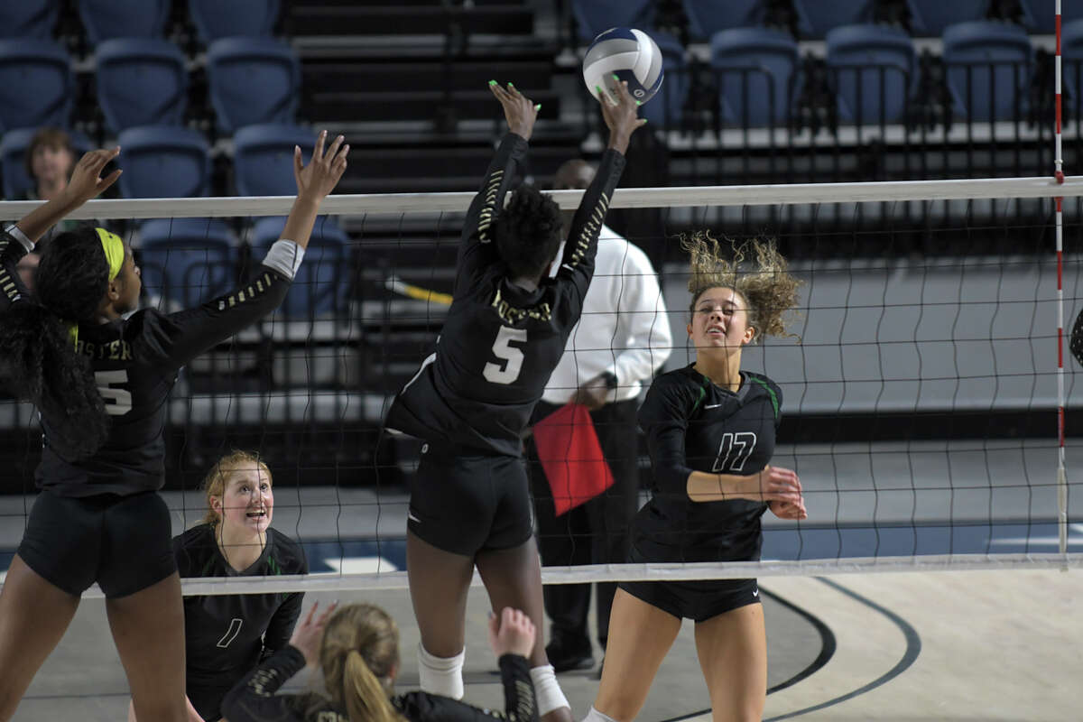 Kingwood Park senior outside hitter Yates Barker (17) finishes a kill against Foster defenders Lauryn Richardson (15) and Alexis Obialo (5) during the third set of their 2018 Region III 5A UIL Volleyball Regional Semi-Final matchup at Delmar Fieldhouse in Houston on Nov. 9, 2018.
