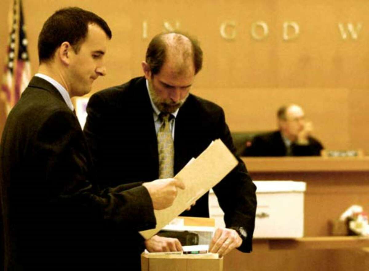 Albany County Chief Assistant District Attorney Michael McDermott, at right, and Assistant District Attorney David Rossi pack up evidence files as they prepare to rest the state's case against Christopher Porco on August 2, 2006.