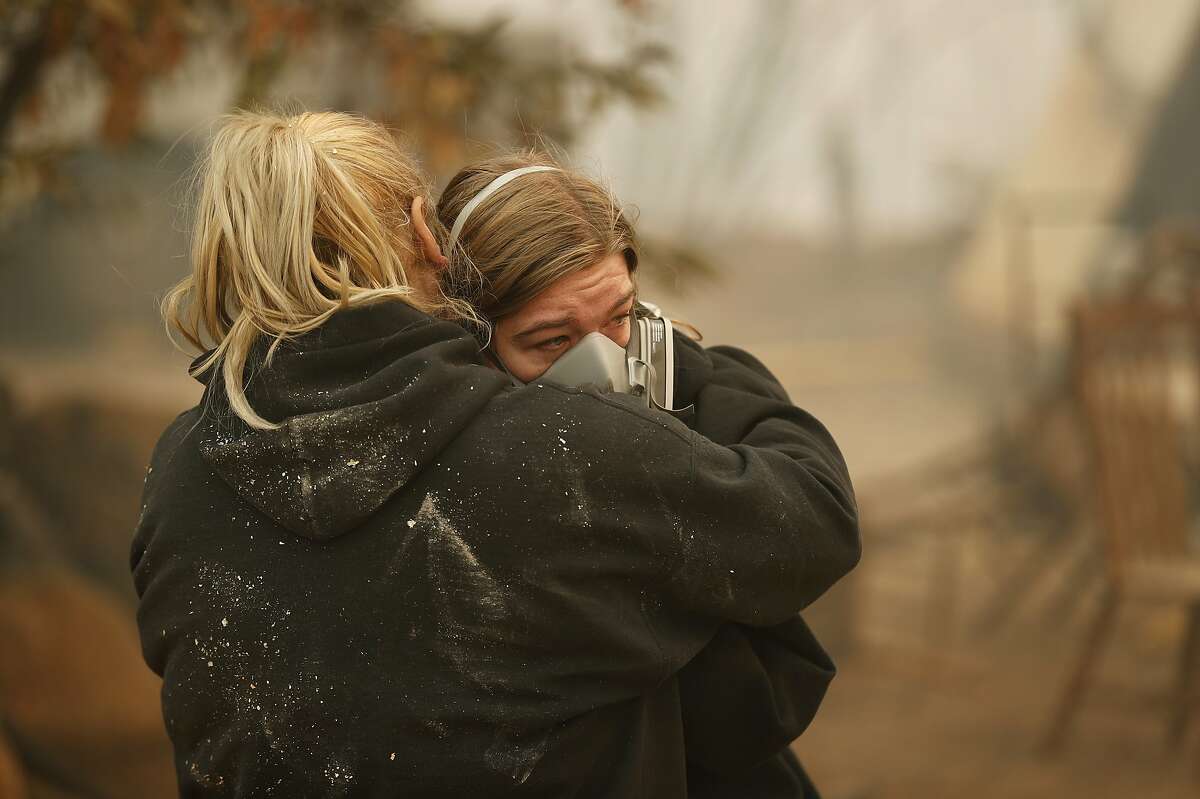 Krystin Harvey, left, comforts her daughter Araya Cipollini at the remains of their home burned in the Camp Fire, Saturday, Nov. 10, 2018, in Paradise, Calif. 