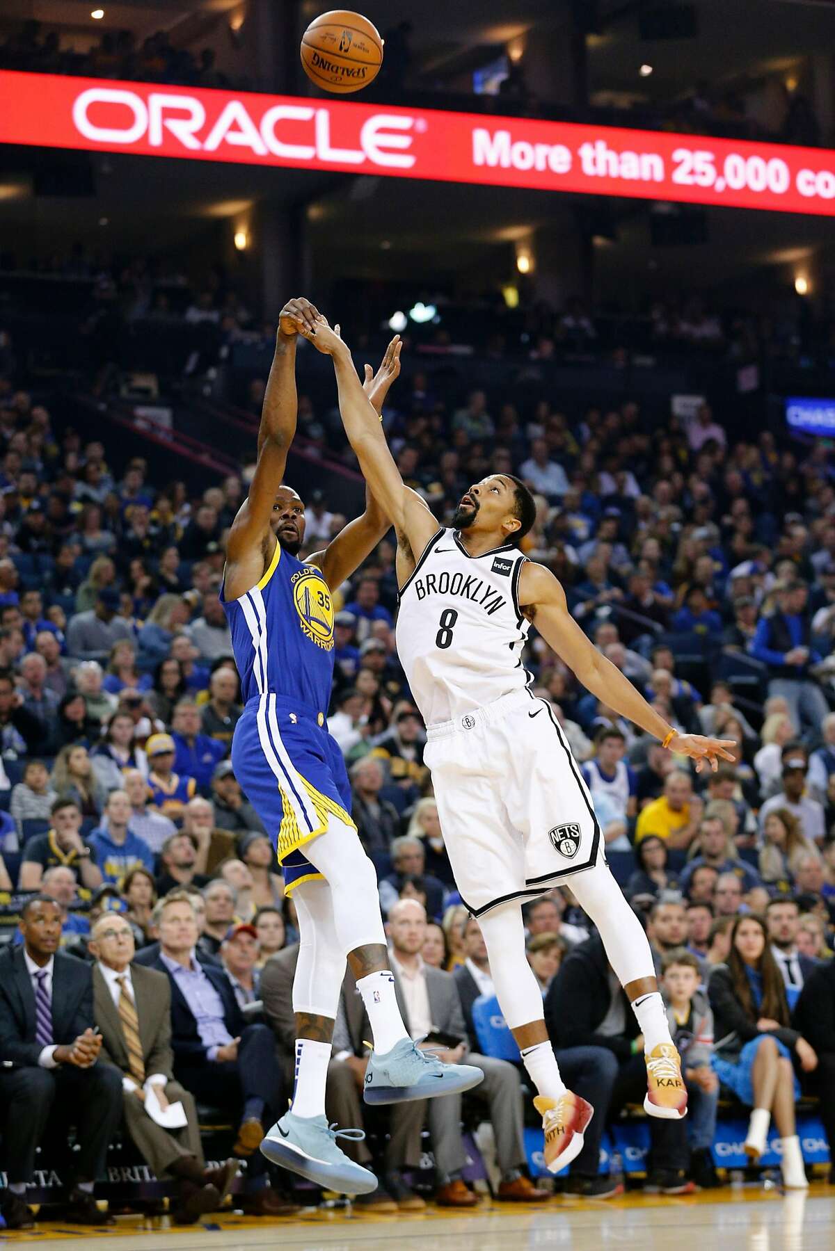 Golden State Warriors forward Kevin Durant (35) makes the shot against Brooklyn Nets guard Spencer Dinwiddie (8) in the second half of an NBA game at Oracle Arena on Saturday, Nov. 10, 2018, in Oakland, Calif. The Warriors won 116-100.