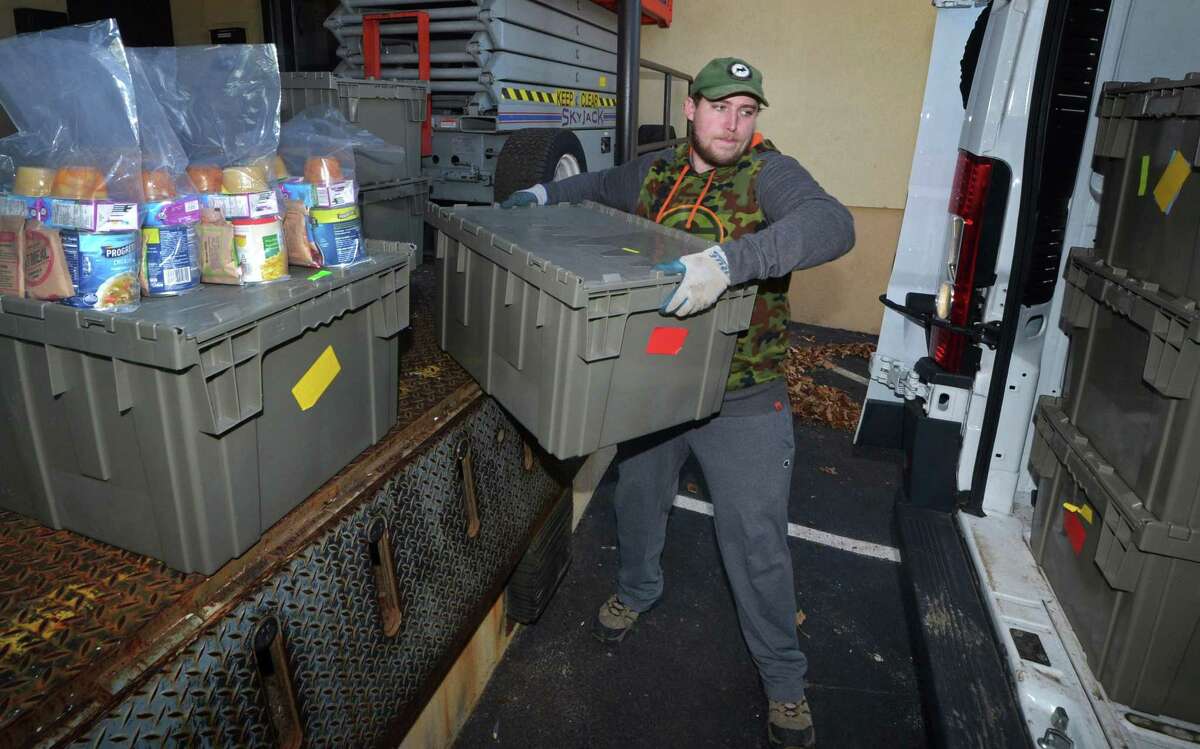 Hunter Van Veghel, delivery driver for Filling in the Blanks, loads up his truck on Thursday at their Main Avenue location in Norwalk. Filling In The Blanks is a nonprofit that fights against childhood hunger by bringing food to schools. The meals are held by social workers or teachers until Friday afternoon and then given to students who need something to eat on the weekends.