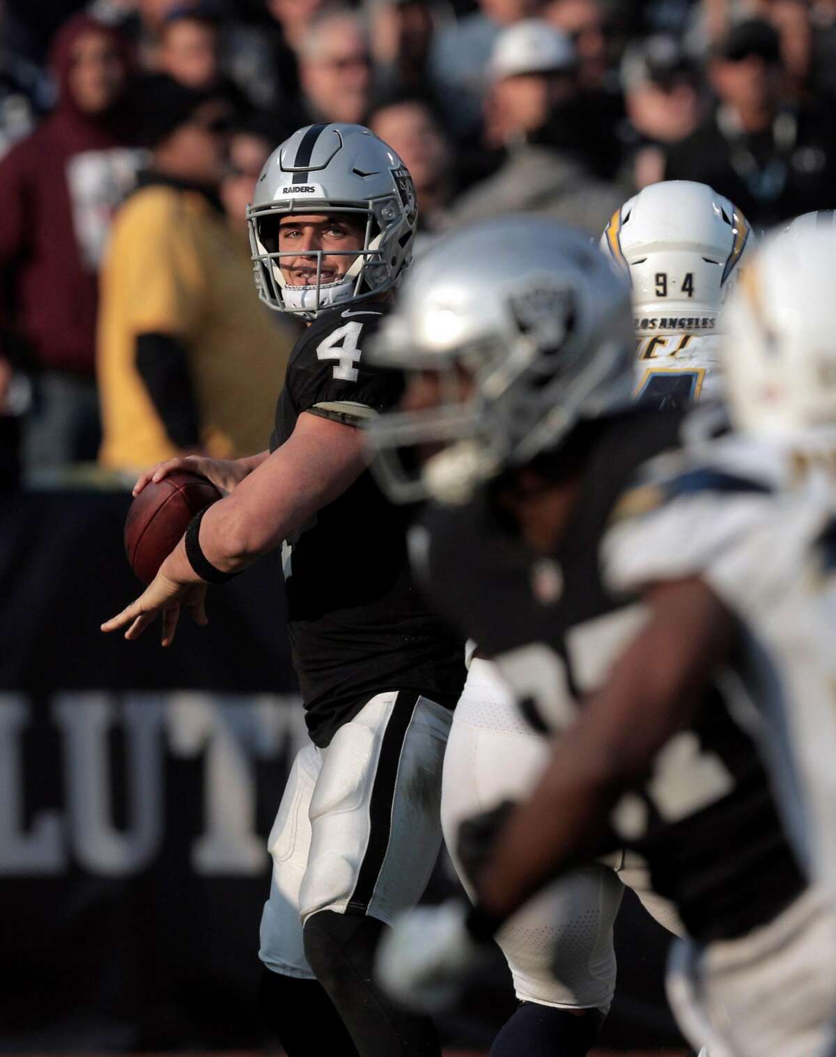 Oakland Raiders quarterback Derek Carr (4) looks at a replay where he fell  over his own offensive lineman during the first half of their NFL game in  Santa Clara, Calif., Thursday, Nov.