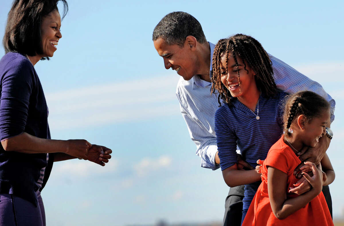 Michelle Obama and her daughters greet Barack Obama at a campaign stop in Colorado in 2008. In her memoir, she writes that she was a reluctant political spouse. (Linda Davidson/The Washington Post)