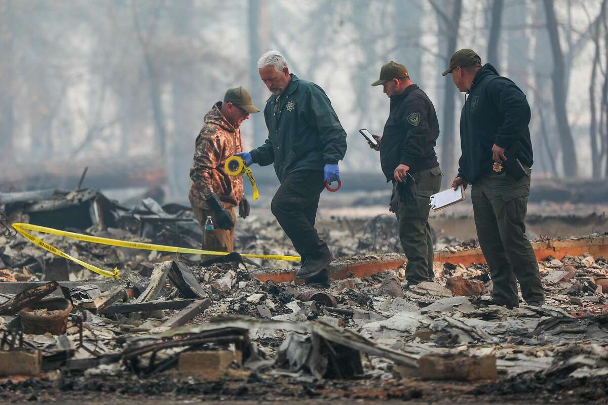 Sheriffs look for fatalities following the Camp Fire in Paradise, California, on Saturday, Nov. 10, 2018.