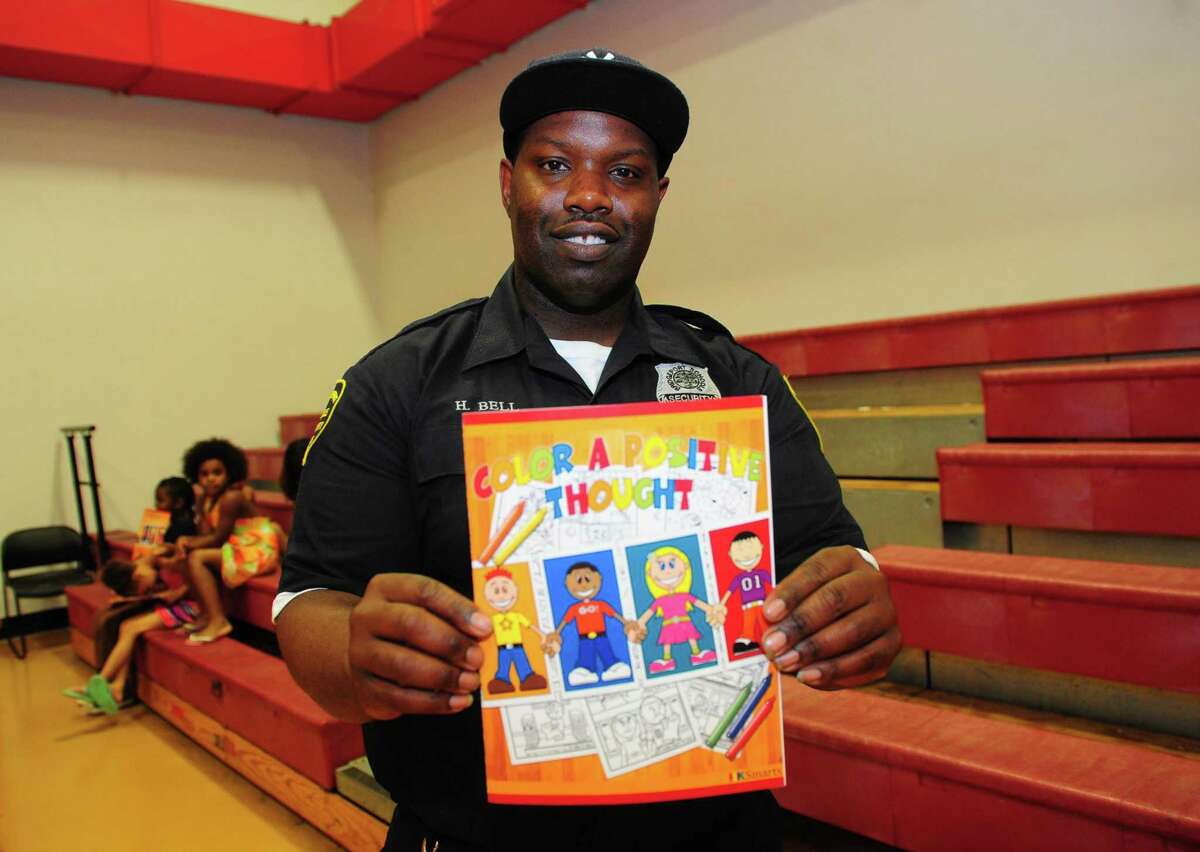 Security officer Harry Bell, who has created a Color a Positive Thought coloring book for kids, spends time mentoring youths at the Trumbull Gardens Community Center in Bridgeport, Conn., on Thursday July 7, 2016. He has organized the first annual Empowering Kids Day planned for July 15 at Seaside Park.
