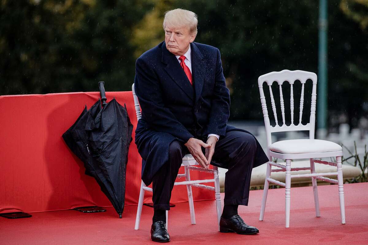 U.S. President Donald Trump looks on while seated during the American Commemoration Ceremony at the Suresnes American Cemetery in Paris, France, on Sunday, Nov. 11, 2018. Trump spoke at a military cemetery near Paris, a day after drawing sharp criticism for canceling a trip to a separate cemetery during centenary commemorations of the end of World War I. Photographer: Marlene Awaad/Bloomberg