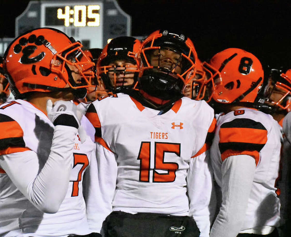 Edwardsville’s Jordan Lewis, center, gets fired up before the start of Saturday’s quarterfinal game at Lincoln-Way East.
