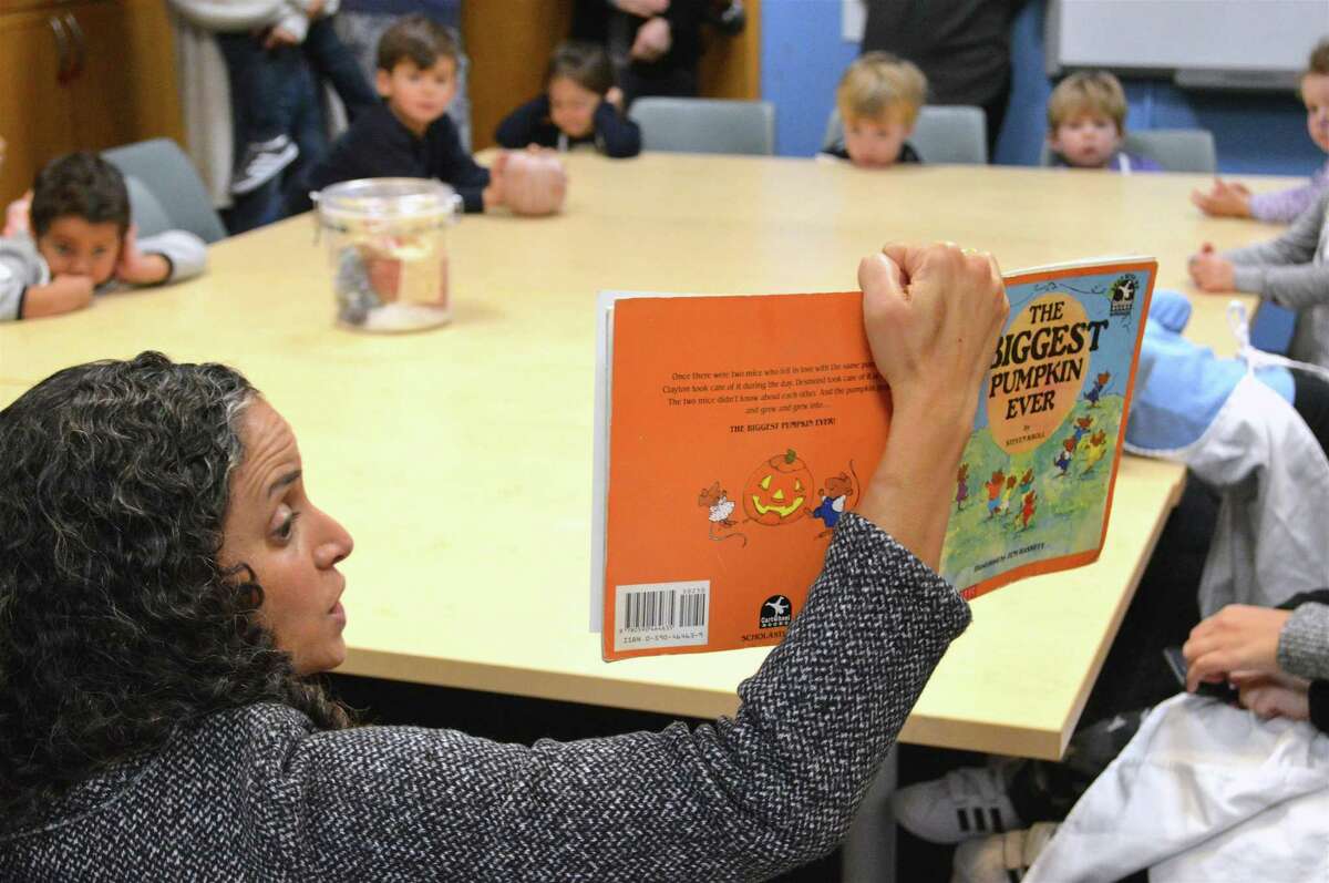 Renan Shvil of Fiddleheads Cooking Studio of Mt. Kisco, N.Y., reads to the group at the Cooking for Kids! class at the New Canaan Library, Friday, Nov. 9, 2018, in New Canaan, Conn.