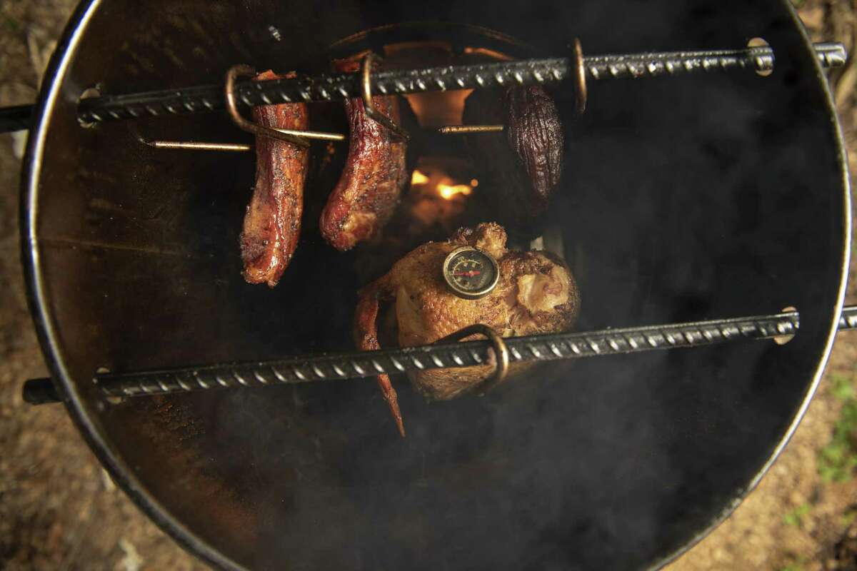 Meat placed inside the Pit Barrel Cooker hangs on hooks placed on rebar inside the device. That allows the air to circulate around the meats at even temperatures.