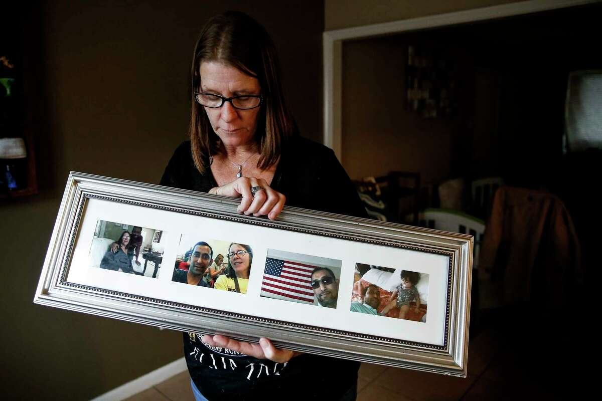 Phyllis Bhuiya holds photos of her and her husband, Faruk Bhuiya, at their home Monday, Nov. 12, 2018, in Houston. Faruk was killed when the convenience store he was working at was robbed this weekend.