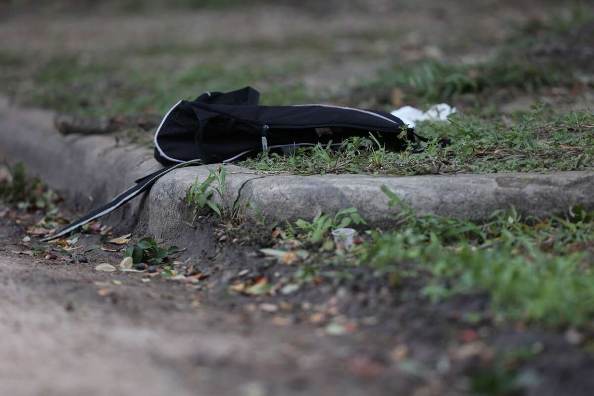 A black backpack is left at the scene where a shooting left one Lamar High School student dead near the intersection of Bammel Lane and Philfall Street on Tuesday, Nov. 13, 2018, in Houston.