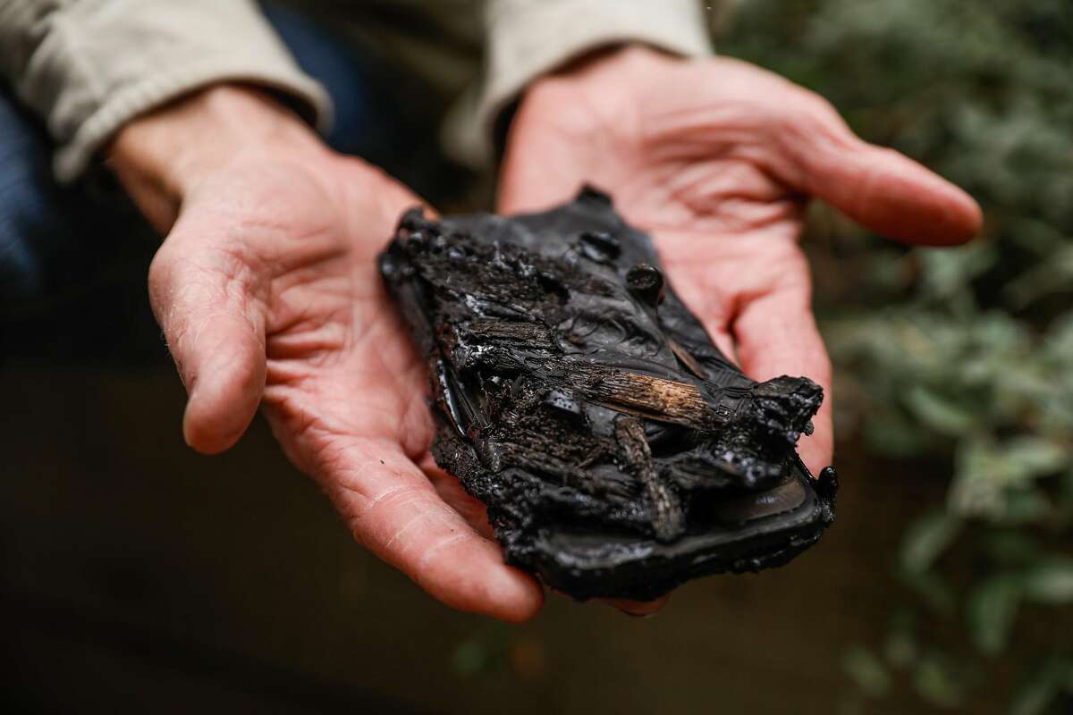 Scott's shows his melted phone in Concow, California, on Tuesday, Nov. 13, 2018. Scott (declined last name) and his family and animals fled into the nearby reservoir as the fire raged through their neighborhood. They were also able to save their 90-year-old neighbor by putting him in a boat and bringing him to shore on the other side.