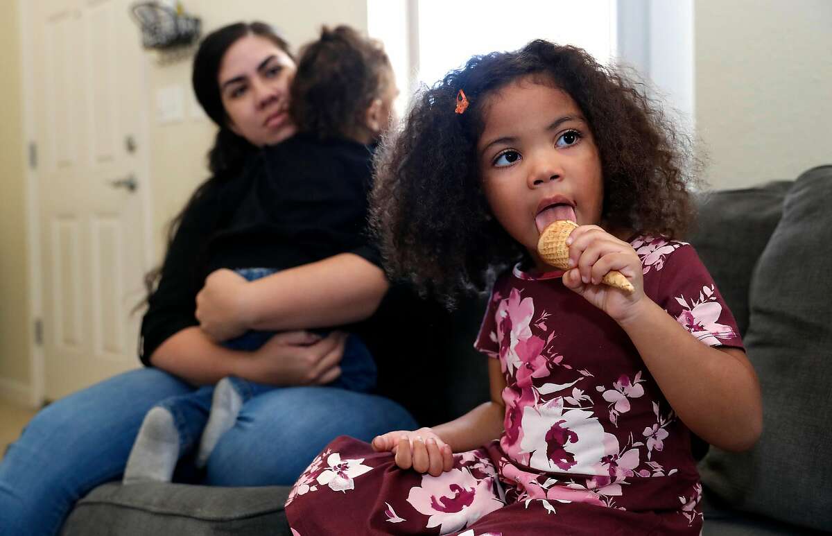 Maipele Burns, 4, enjoys a chocolate ice cream cone while sitting in the living room of her home in Camarillo, Calif., with her mother Carlene and brother Elijah, 2, on Oct. 18, 2018. Maipele was diagnosed at the age of 2 with Acute flaccid myelitis, causing permanent paralysis in her right arm. (Mel Melcon/Los Angeles Times/TNS)
