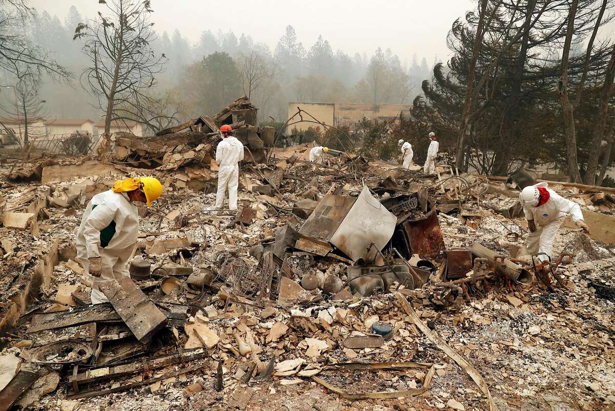 Fire personnel search for fire victims in the rubble of the Shelter Cove Apartments in aftermath of Camp Fire in Paradise, Calif. on Tuesday, November 13, 2018.