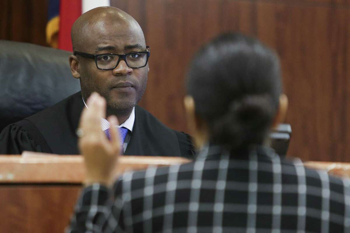 Judge Darrell Jordan, left, goes through his docket at the Harris County Criminal Courthouse Tuesday, May 9, 2017 in Houston. Jordan has testified against other judges in Harris County in a federal lawsuit claiming that by setting high bonds for poor people accused of low-level offenses and pose no danger or flight risk, the system is set up to jail people merely because they are poor. Judge Jordan has abolished the practice in his own courtroom. ( Michael Ciaglo / Houston Chronicle)