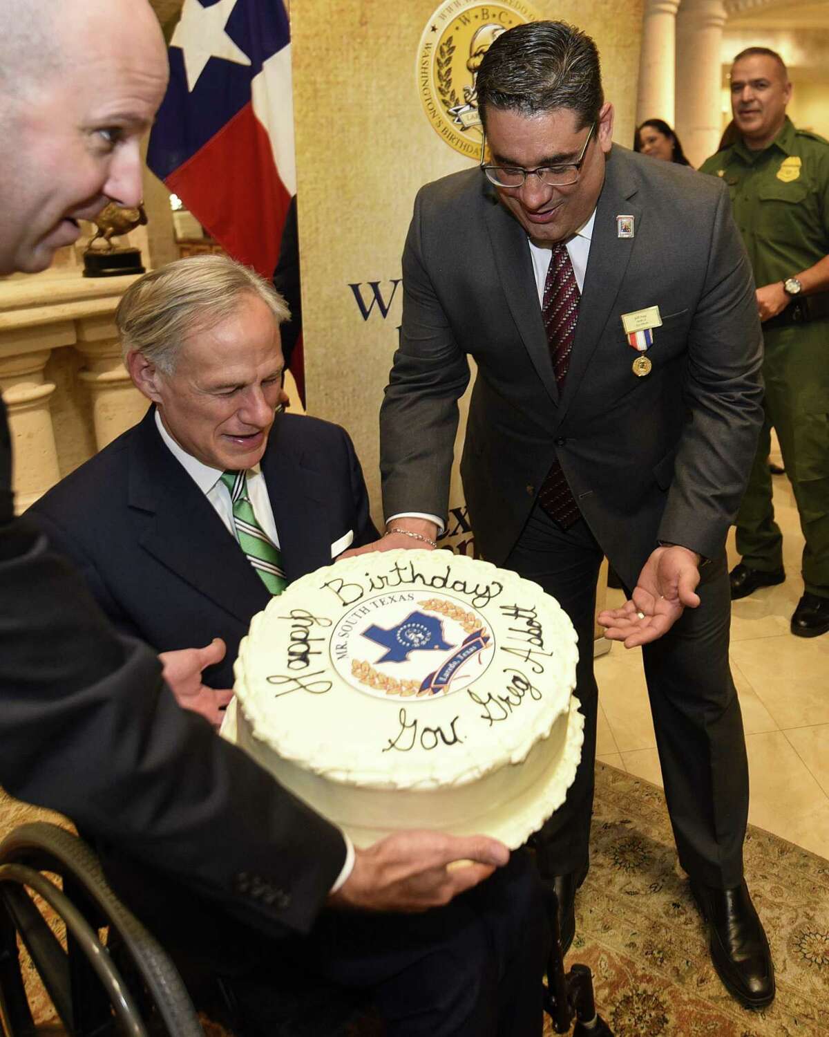 El ex funcionario de WBCA Jeff Puig le entrega un pastel de cumpleaños al gobernador de Texas Greg Abbott para celebrar su cumpleaños. El gobernador fue nombrado Mr. South Texas 2019, el martes 13 de noviembre de 2018.